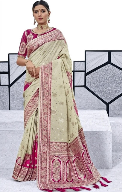 Elegant Traditional Saree with Modern Twist A woman wearing a traditional saree with a light green body and intricate pink border, paired with a matching pink blouse, standing against a modern geometric background.