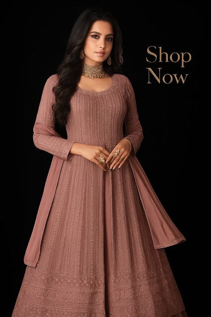 Elegant Mauve Anarkali - Shop Now Woman wearing an elegant mauve embroidered Anarkali suit, styled with a matching dupatta, statement rings, and a gold choker necklace, posing gracefully against a black background with "Shop Now" written in gold on the right.